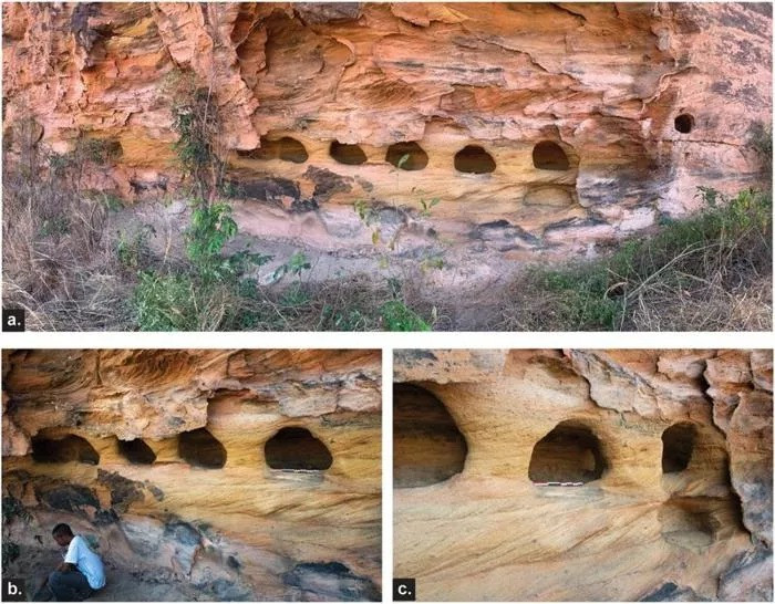 Small niches carved into the sandstone rock.