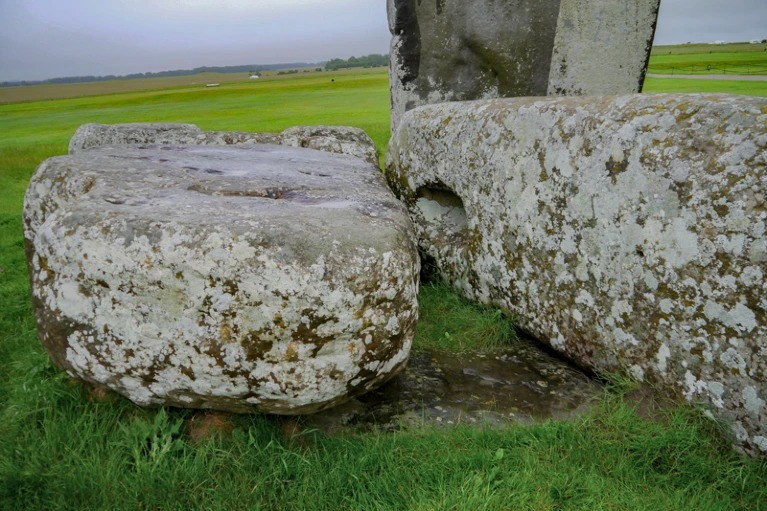 The Altar Stone is a greenish, partially buried piece of sandstone.