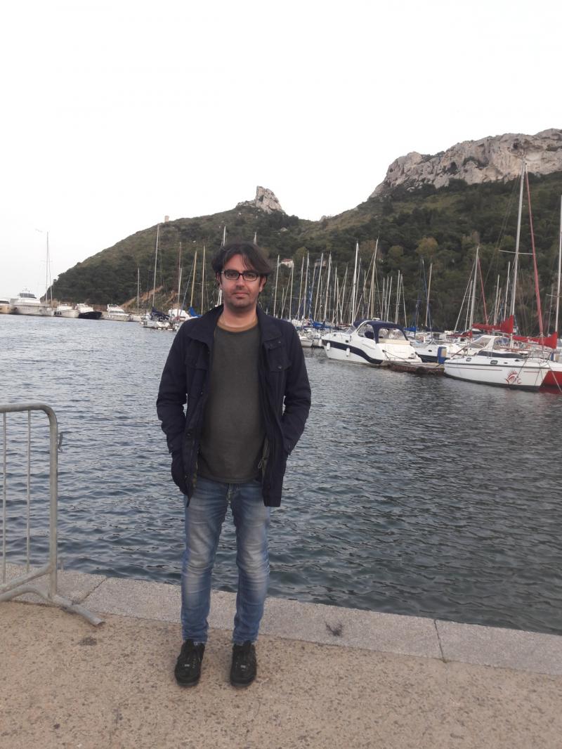 Me at the small harbor of Marina Piccola in Cagliari. In the background the famous Saddle of the Dev