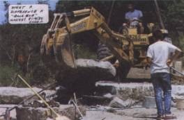 Fig. 8 A power shovel lifts the upper bench that protects the footprints (Photo Hugh Miller)